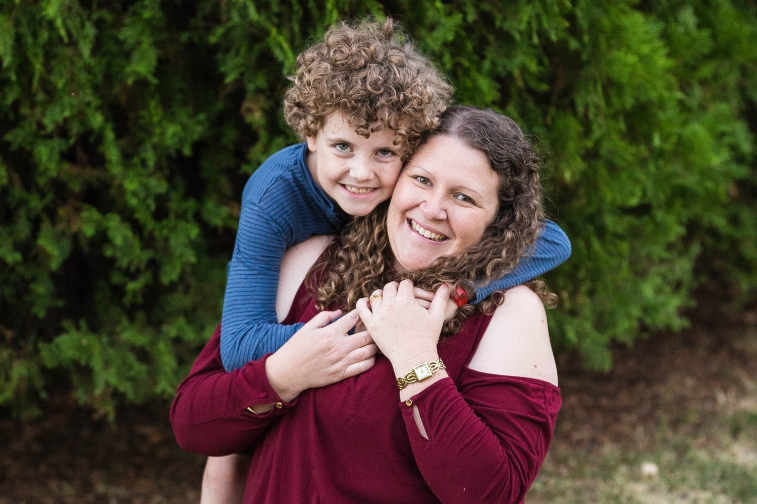 Son holding his mum in park